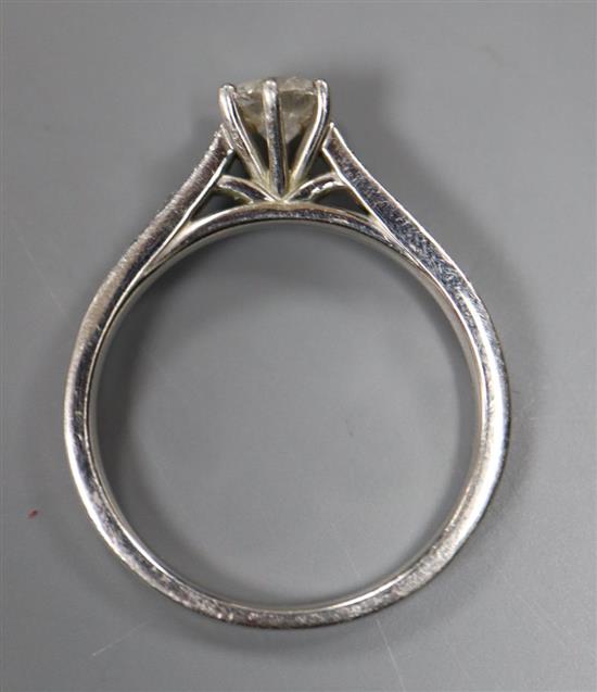 A modern platinum and single stone diamond ring, with diamond set shoulders, size N, gross 4.5 grams.